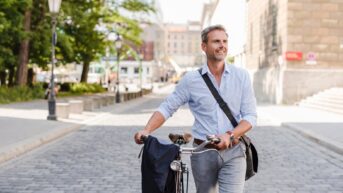 a man riding a bike down a street