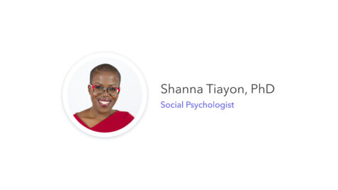 a woman with glasses and a red top