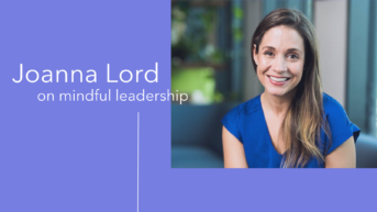 a smiling woman with long hair and blue shirt