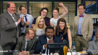 a group of people standing around a computer