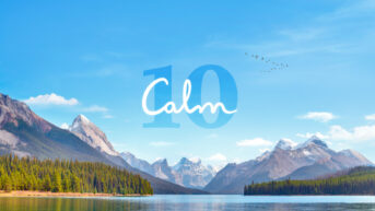 the word calm written over a lake with mountains in the background