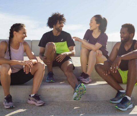 a group of people sitting on steps talking