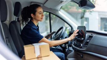 a woman sitting in the driver's seat of a car
