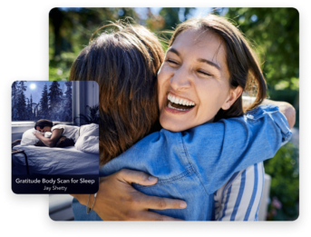 two women hugging each other in front of a bed