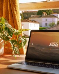 a laptop computer sitting on top of a wooden table