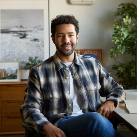 a man sitting at a desk in front of a computer
