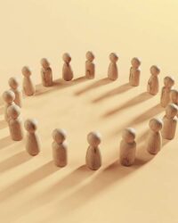 a group of wooden people standing in a circle