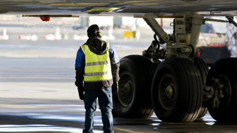 a man standing in front of an airplane