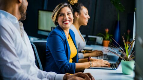 employees smiling at desks
