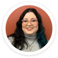 a woman wearing glasses and a turtle neck sweater