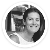 a black and white photo of a smiling woman