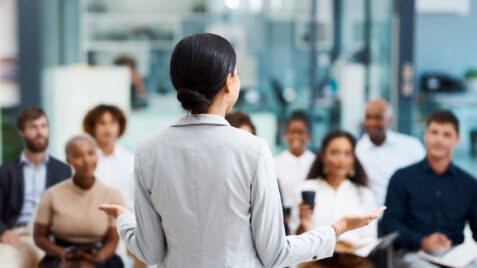 a woman standing in front of a group of people