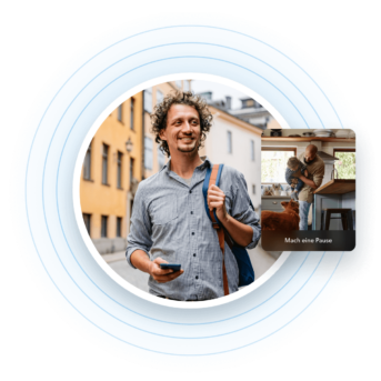 a man with curly hair holding a cell phone