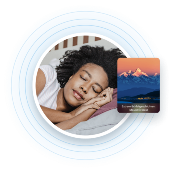 a woman sleeping in bed with mountains in the background