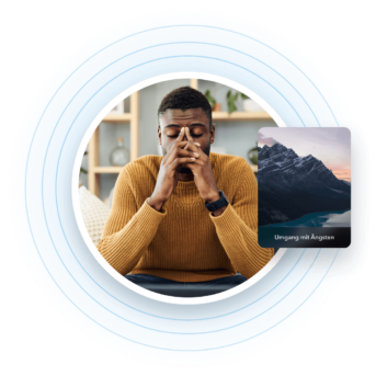 a man sitting at a desk with his hands to his face