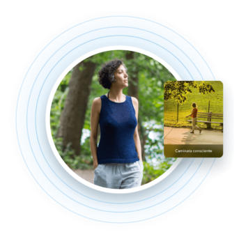 a woman standing in front of a park bench