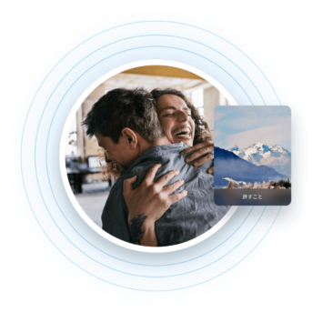 a man holding a woman in his arms with mountains in the background