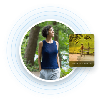 a woman in blue shirt standing next to a tree