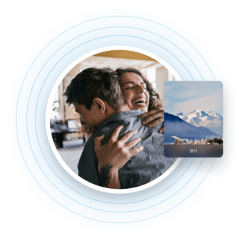 a man holding a woman in his arms with mountains in the background