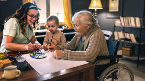 Caregiver with child and elderly parent