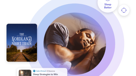 a man laying in bed next to a book