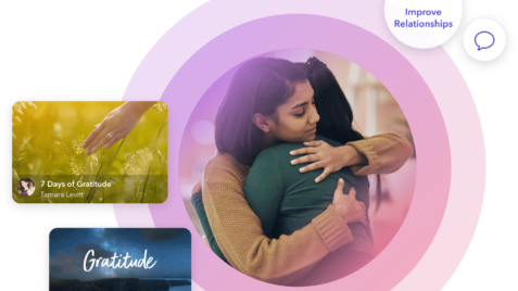 a woman hugging a man in front of a cell phone