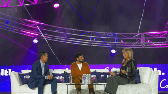 a group of people sitting on top of a white couch
