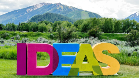 a colorful sign that says ideas in the grass