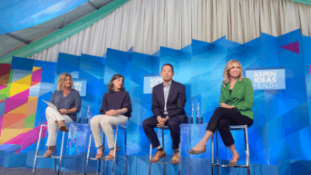 a group of people sitting on chairs on a stage