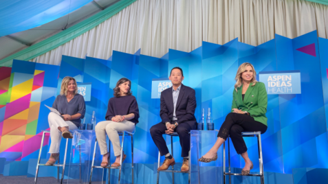 a group of people sitting on chairs on a stage