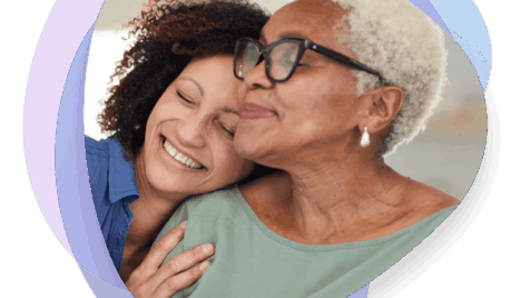 an older woman hugging a younger woman