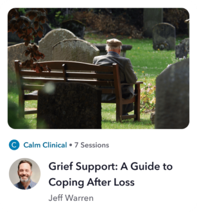 a man sitting on a bench in a cemetery