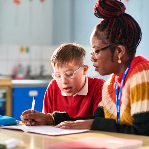 a woman and a boy are sitting at a table