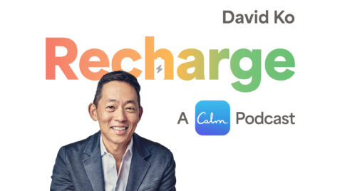 a man in a suit is smiling for the camera