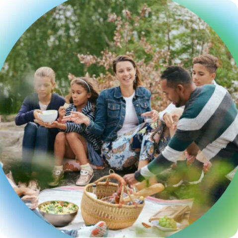 a group of people sitting around a picnic table
