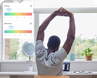 a man sitting at a desk with his arms in the air