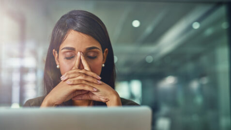 Woman executive feeling stress at her computer