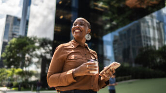 a woman standing in front of a tall building