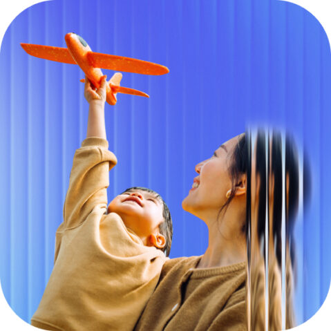 a woman holding a toy airplane in the air