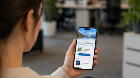 a woman holding a cell phone in her hand