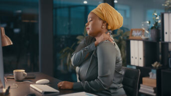 a woman with a turban sitting at a desk