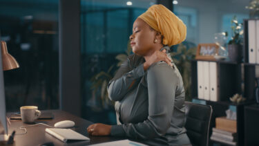 a woman with a turban sitting at a desk