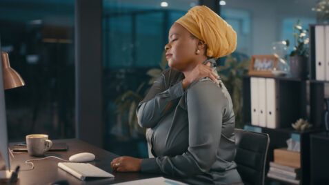 a woman with a turban sitting at a desk